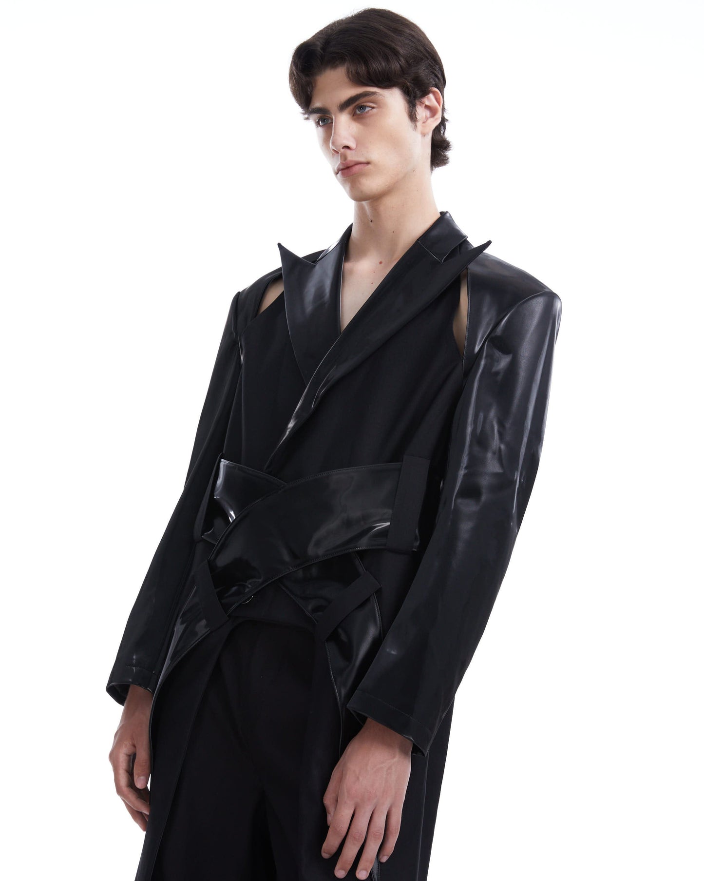 Person wearing a black coat on a white background