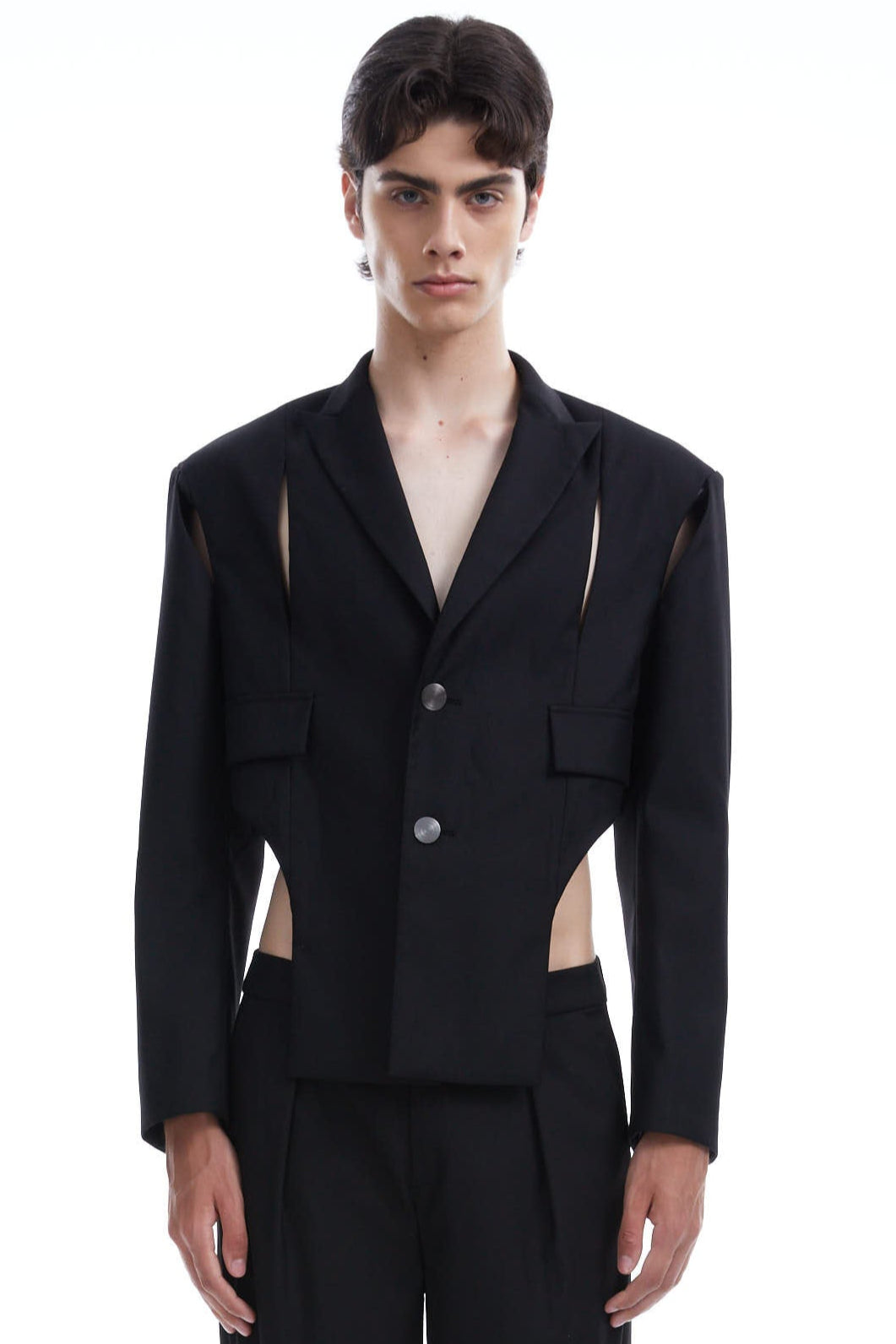 Person wearing a black suit with cut-out design on a white background
