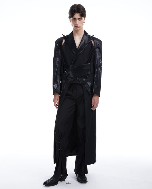 Person wearing a black outfit with a textured design on a white background